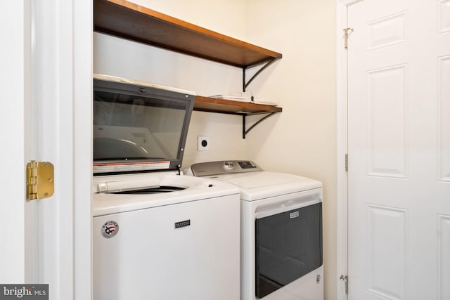 clothes washing area with washing machine and clothes dryer