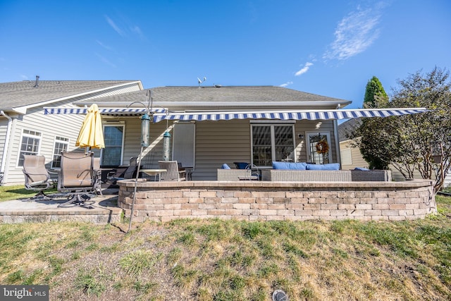 back of house with an outdoor hangout area and a patio area