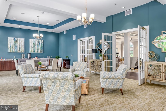 living room featuring french doors and a chandelier