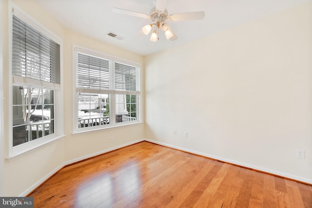 empty room with ceiling fan and light wood-type flooring