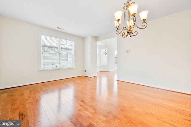 interior space featuring an inviting chandelier and light hardwood / wood-style flooring