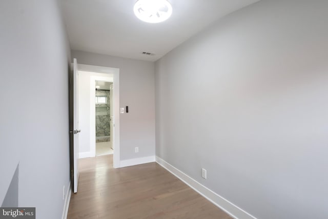 corridor with hardwood / wood-style floors