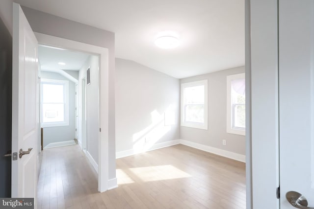 empty room with light wood-type flooring and a healthy amount of sunlight