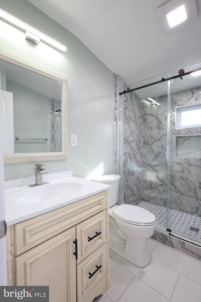 bathroom featuring vanity, toilet, and walk in shower