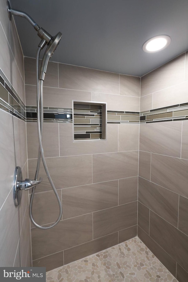 bathroom with a tile shower