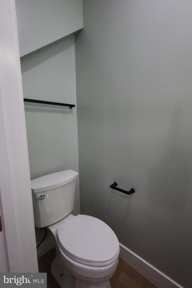 bathroom featuring toilet and wood-type flooring