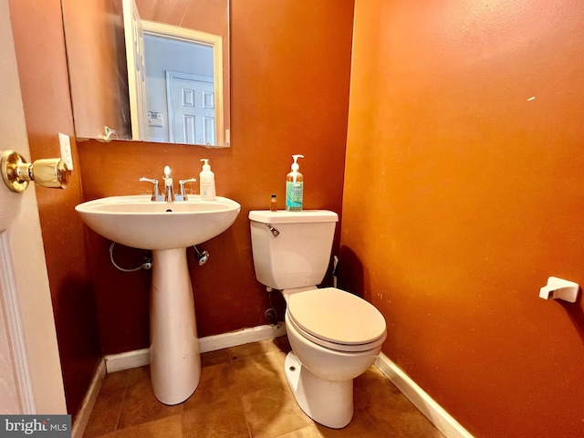 bathroom with tile patterned flooring and toilet