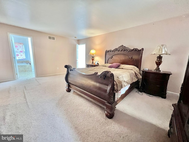 bedroom featuring carpet floors and connected bathroom