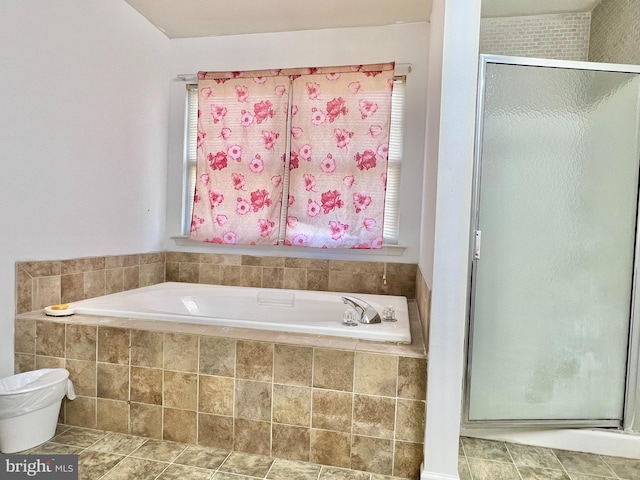 bathroom featuring plus walk in shower and a healthy amount of sunlight