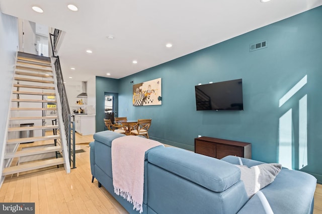 living room with plenty of natural light and light hardwood / wood-style flooring