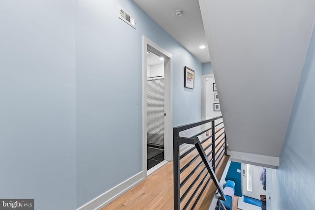 hallway with light hardwood / wood-style flooring