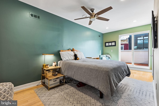 bedroom with ceiling fan and light hardwood / wood-style floors