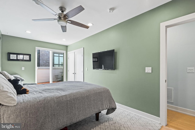 bedroom featuring light hardwood / wood-style floors and ceiling fan