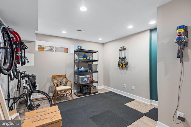 workout room with wood-type flooring