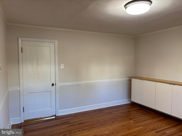 unfurnished room with dark hardwood / wood-style flooring and crown molding