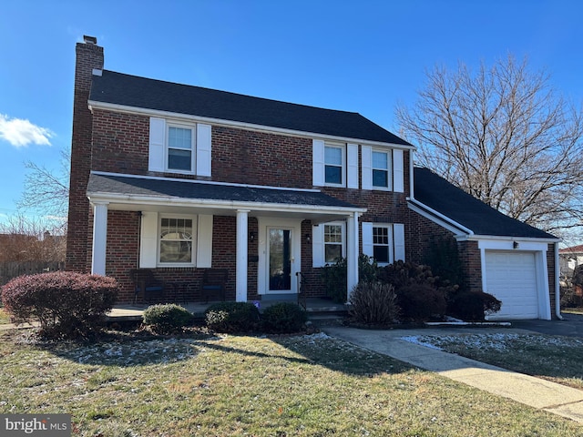 view of front of property with a front yard, a porch, and a garage