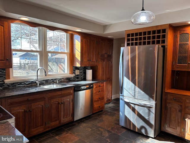 kitchen featuring decorative light fixtures, stainless steel appliances, tasteful backsplash, and sink