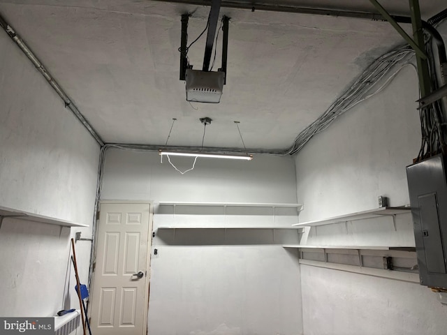 garage with electric panel and a garage door opener