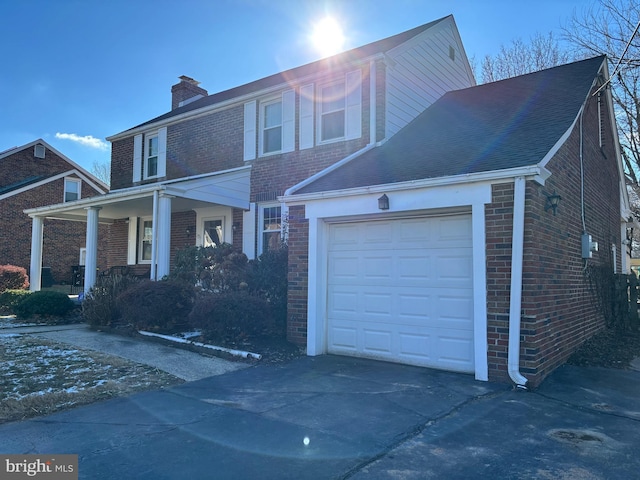 view of front property with a porch and a garage