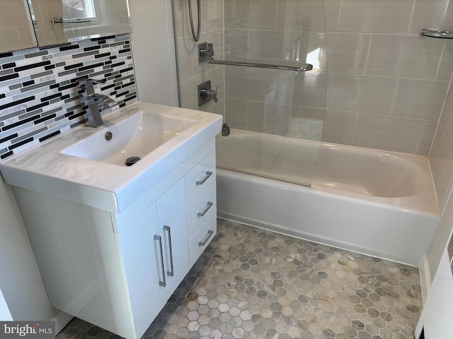 bathroom featuring backsplash, vanity, and  shower combination