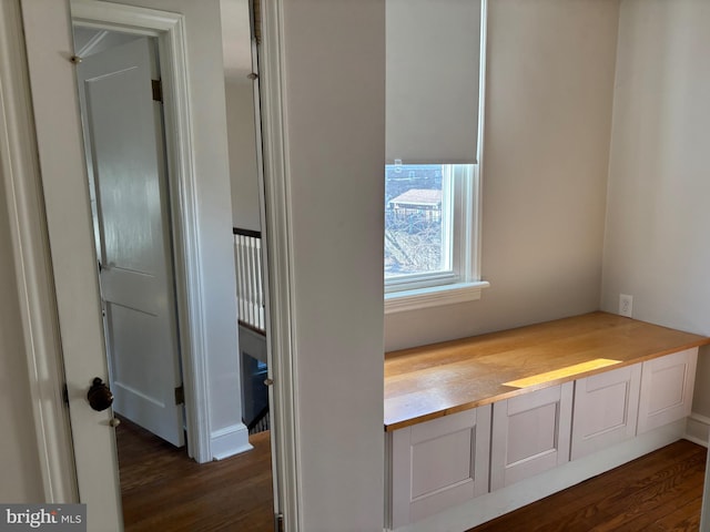 hallway with dark hardwood / wood-style flooring