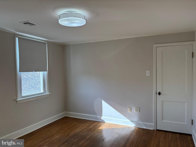 unfurnished room featuring dark hardwood / wood-style flooring