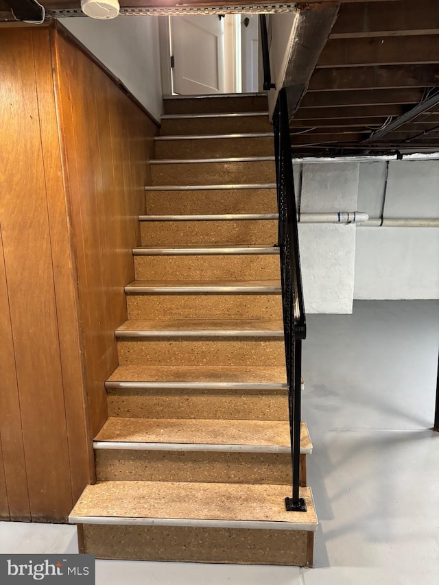 stairs featuring concrete floors