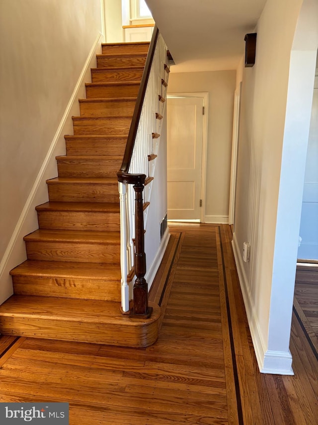 stairway featuring wood-type flooring