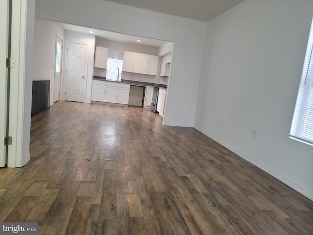 unfurnished living room featuring dark hardwood / wood-style floors