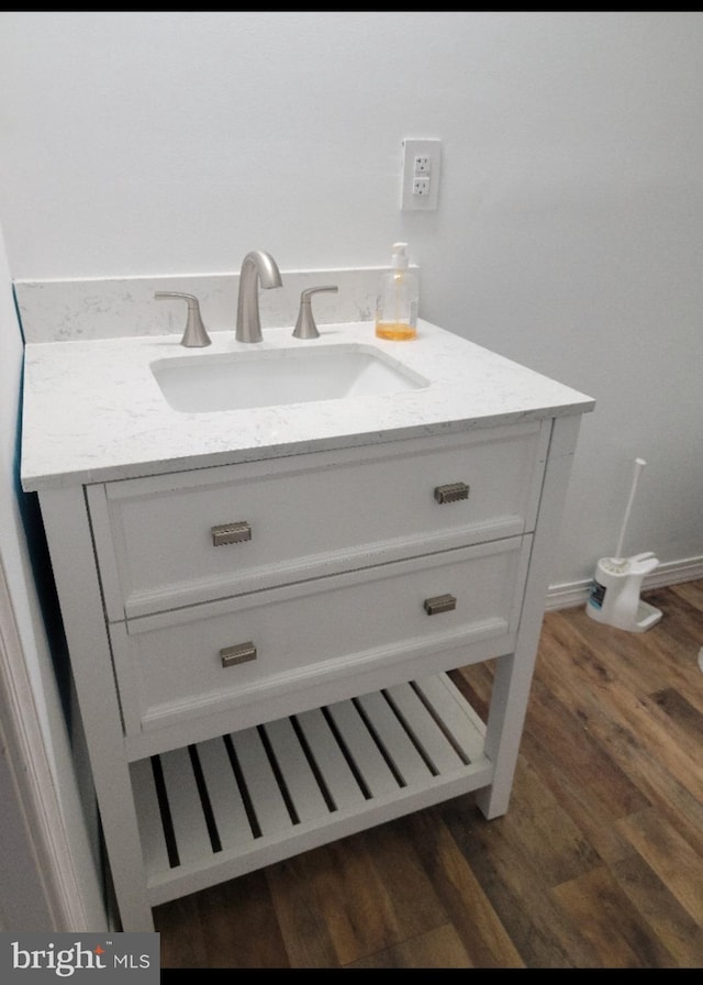 details featuring hardwood / wood-style floors and vanity