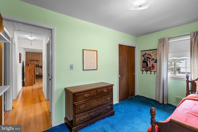 bedroom featuring light colored carpet and a closet