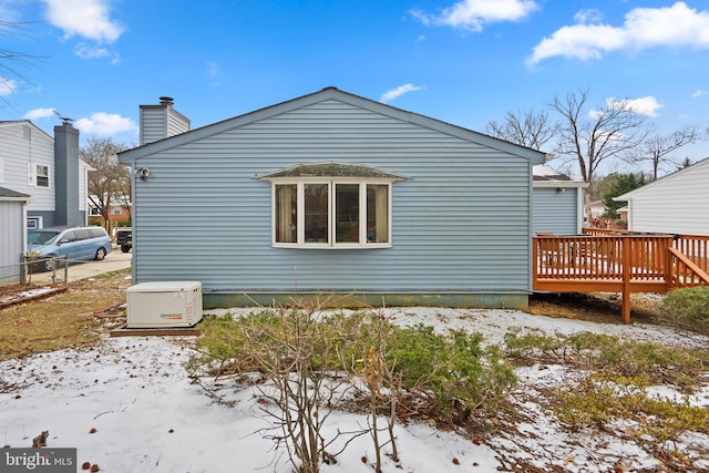 view of snow covered exterior featuring a deck