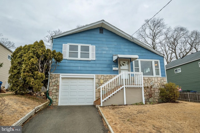 view of front of property with a front yard and a garage