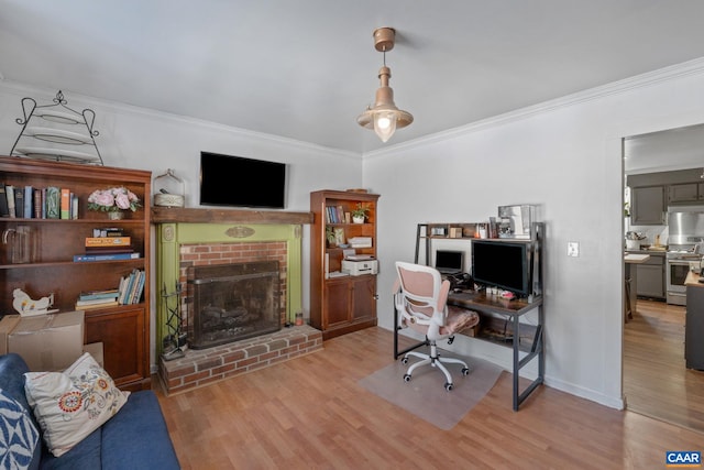 office with a brick fireplace, light hardwood / wood-style floors, and ornamental molding