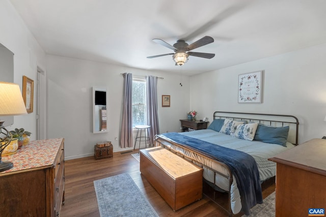 bedroom featuring ceiling fan and dark wood-type flooring