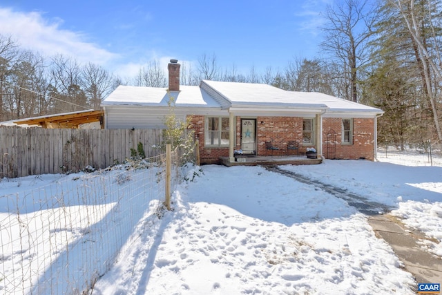 view of snow covered back of property