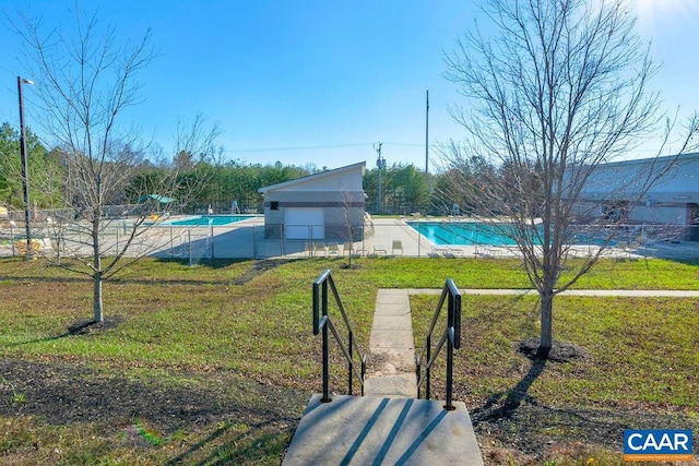 view of yard featuring a community pool