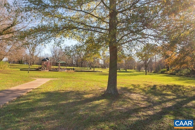 view of home's community with a yard and a playground