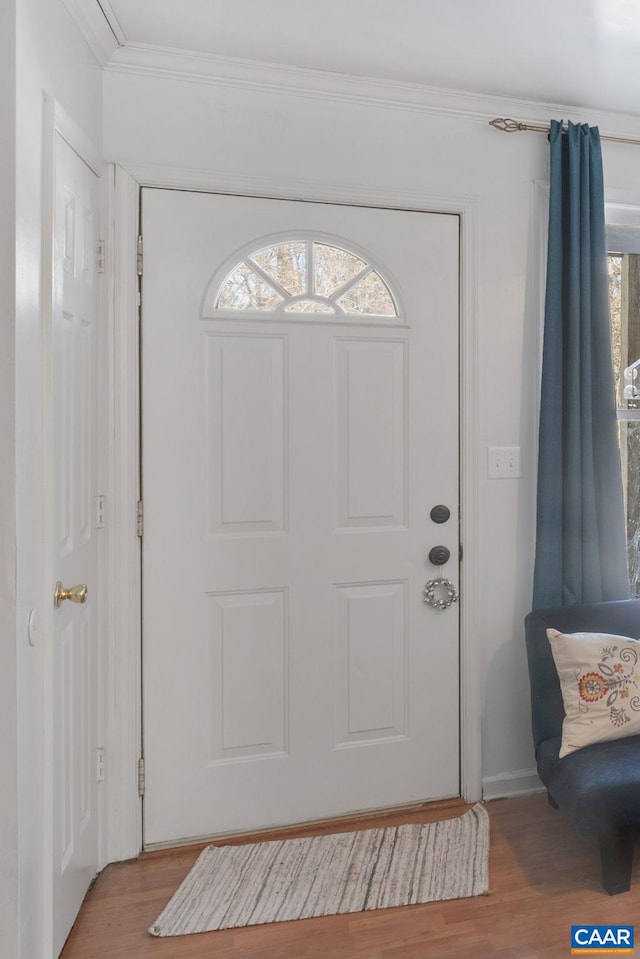 foyer featuring light hardwood / wood-style flooring and ornamental molding