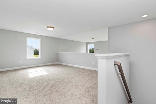 unfurnished room featuring carpet floors and plenty of natural light