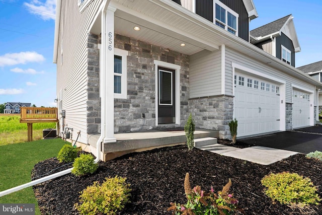 view of front of house with a garage and central AC