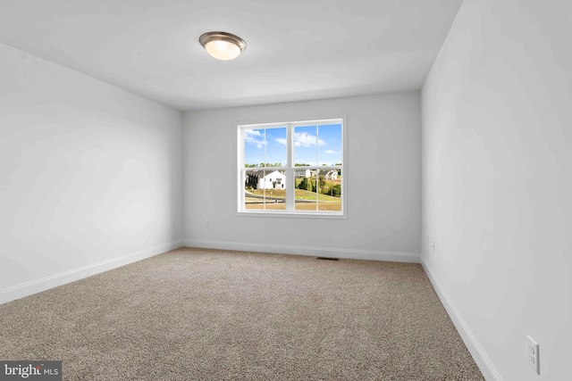 unfurnished room featuring carpet