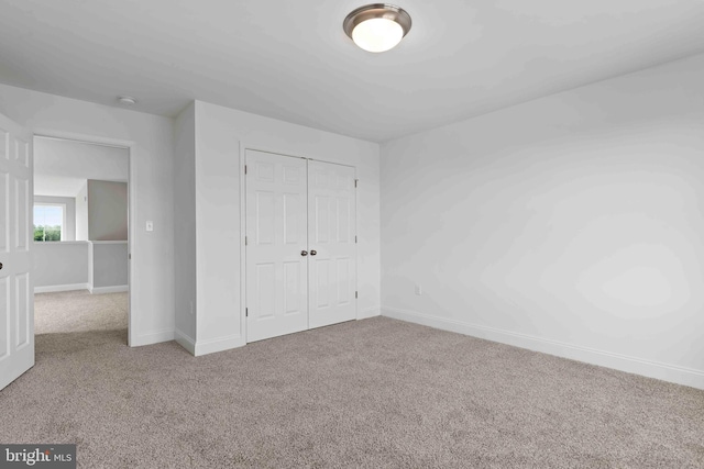 unfurnished bedroom featuring a closet and carpet