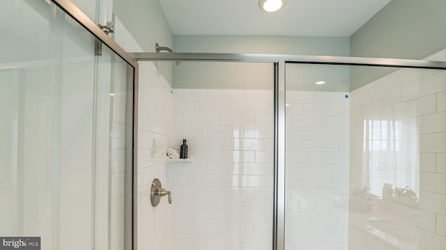 bathroom with a shower with shower door