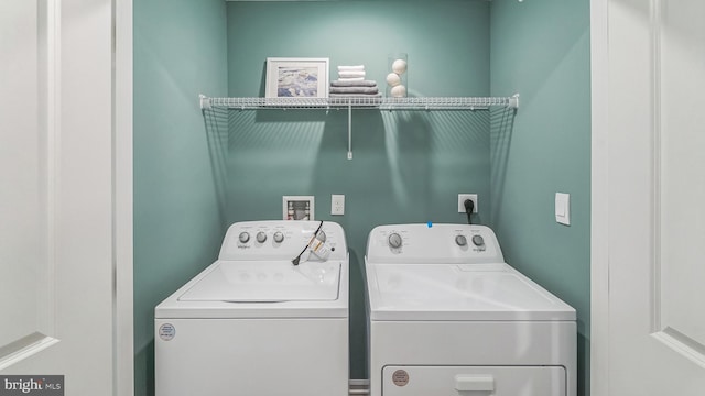 washroom with washing machine and clothes dryer