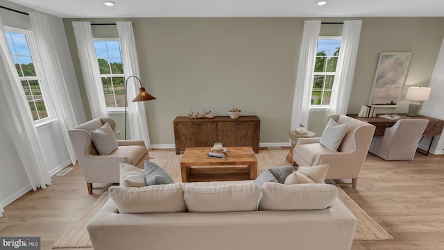 living room with plenty of natural light and light hardwood / wood-style floors