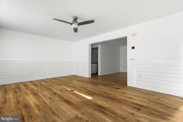 unfurnished room featuring ceiling fan and dark hardwood / wood-style flooring