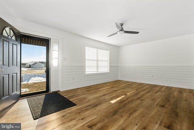 foyer with ceiling fan and wood-type flooring