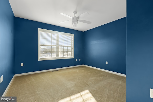 spare room with carpet flooring and ceiling fan