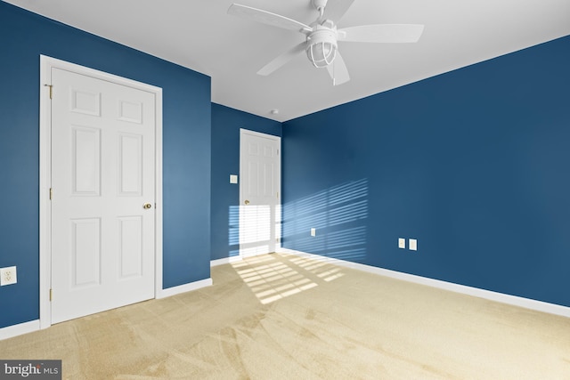 unfurnished bedroom featuring carpet floors and ceiling fan